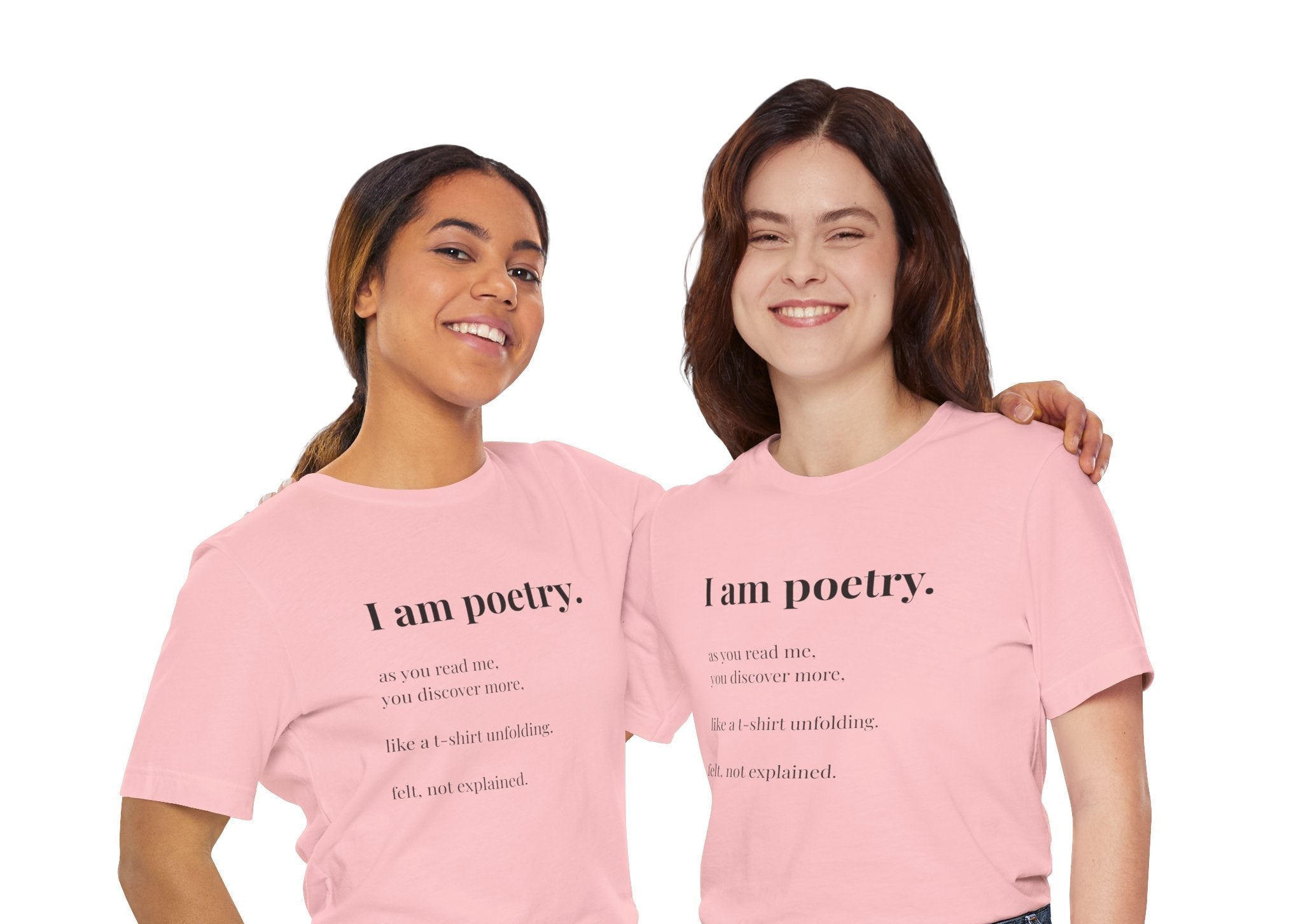 Two women stand in pink 'I am poetry' t-shirt, against a white background